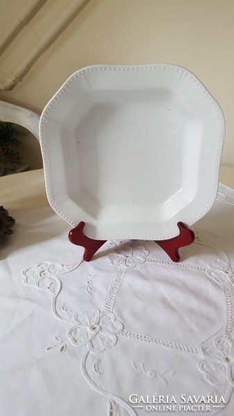 An octagonal serving bowl with a beaded pattern
