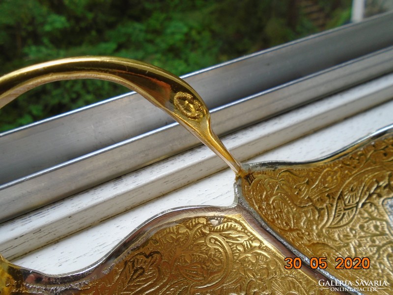 Handmade table centerpiece with a pair of gilded plastic swans, detailed relief patterns