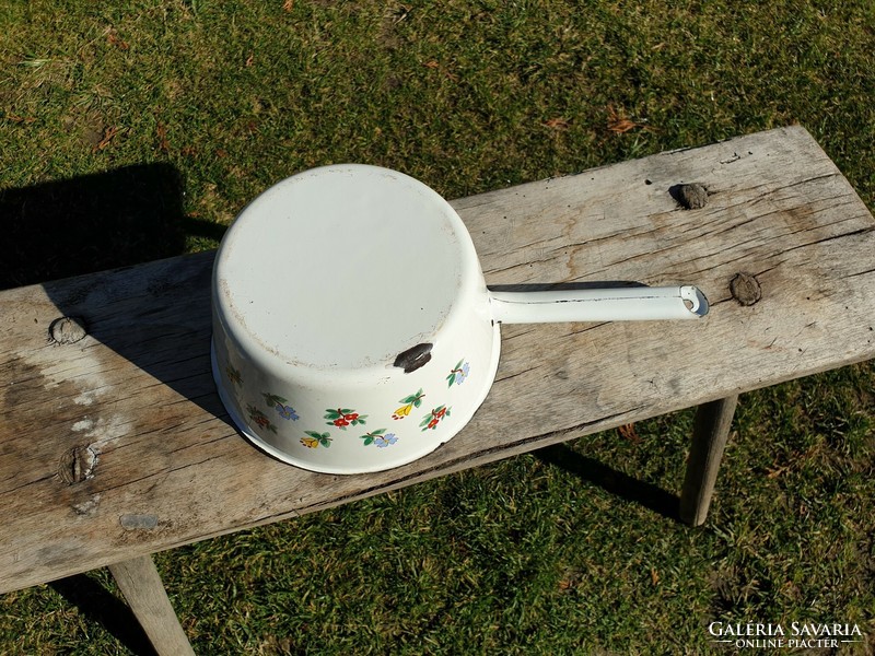 Old vintage enamel flower pattern in enameled large bowl with pouring milk