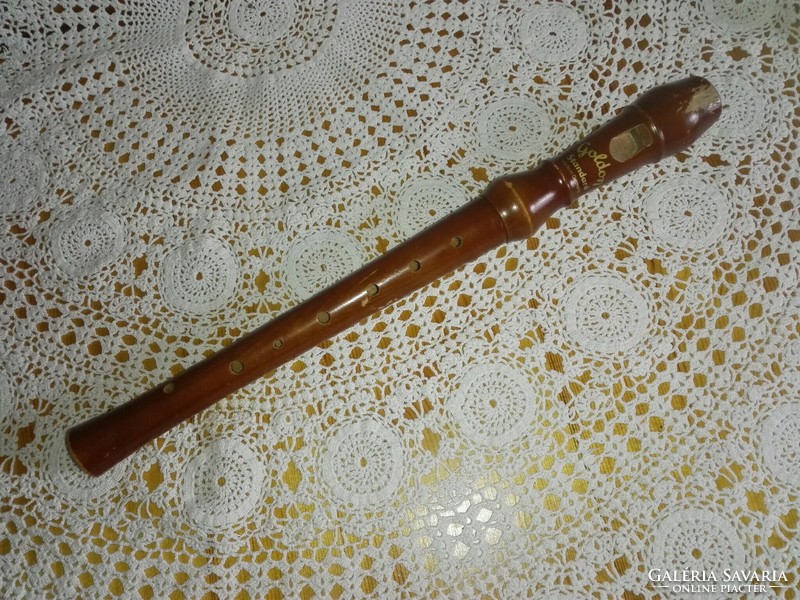 Golden, wooden flute.