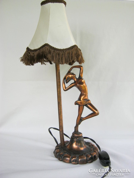 Female nude with metal lamp