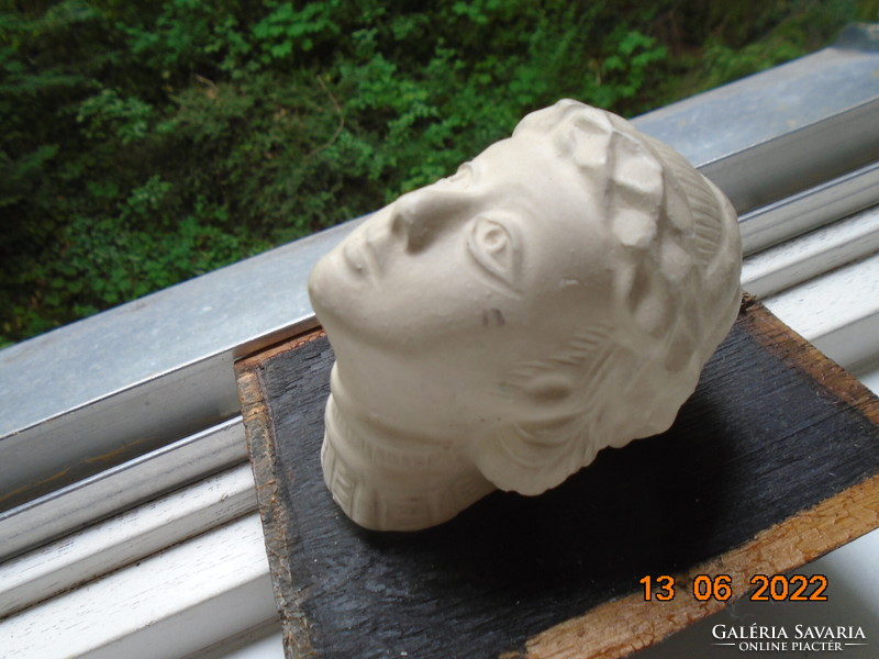 Female plaster head in ancient style with laurel wreath