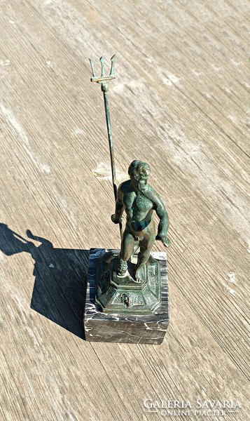 Antique bronze mercury statue on a marble pedestal