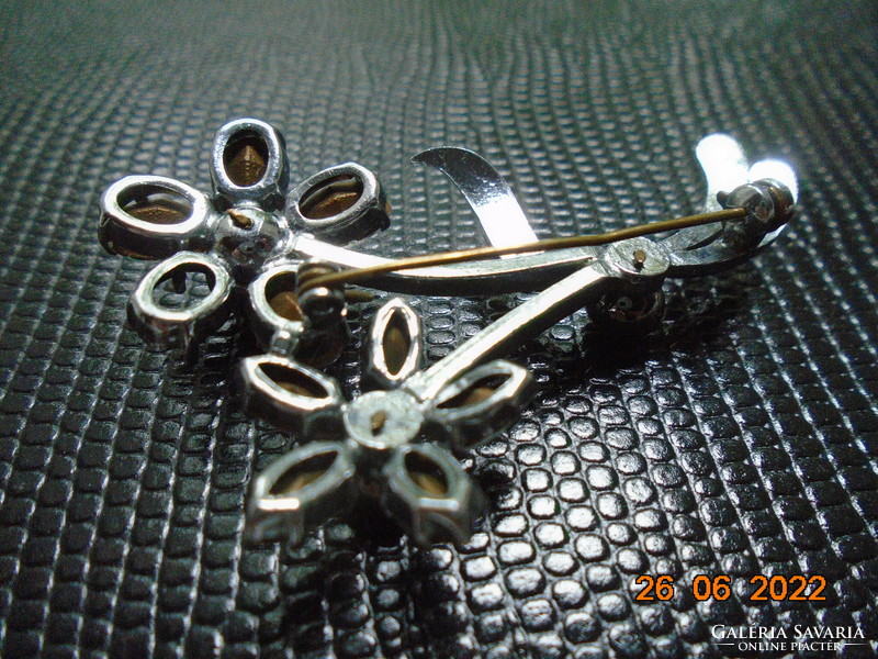 Silver-plated flower brooch with 3 black stones, polished, faceted rock crystal petals in a claw socket