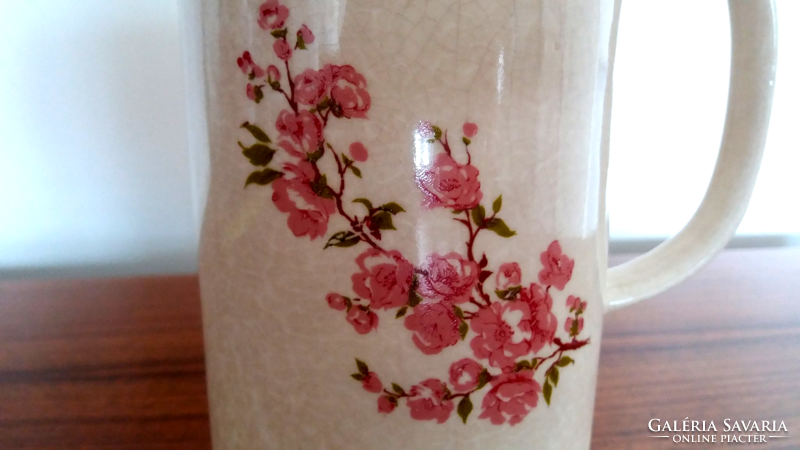 Old ceramic jug with cherry blossom spout