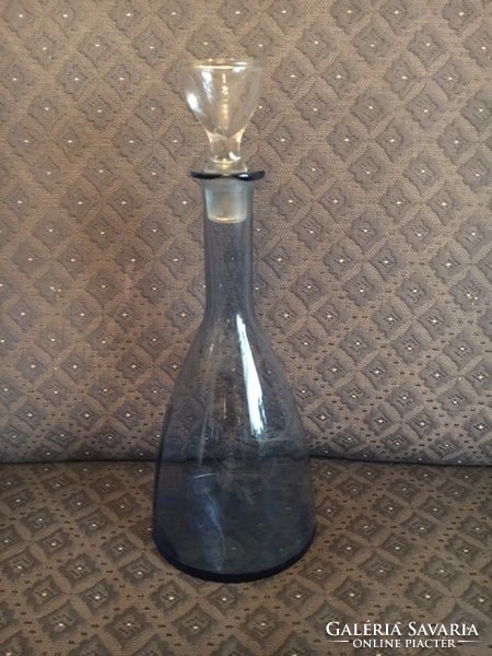 Torn, engraved, vintage, blue glass bottle with stopper