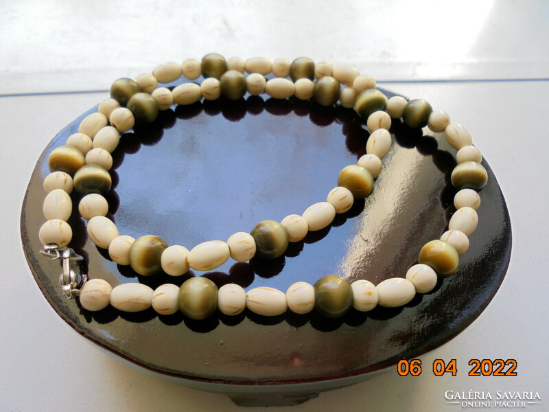 Necklaces made of carved bone and tiger eye beads