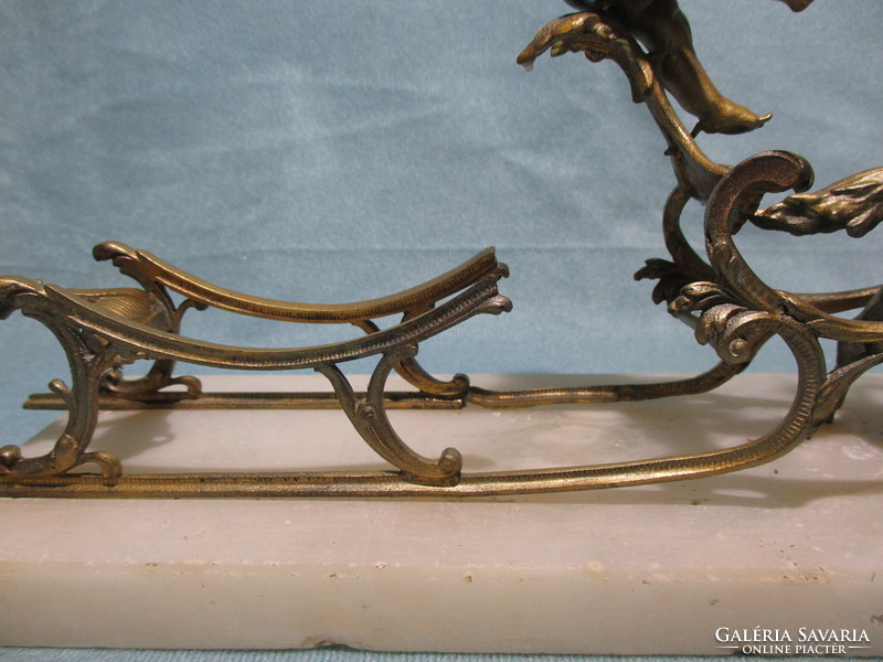 Antique metal sleigh on a stone slab