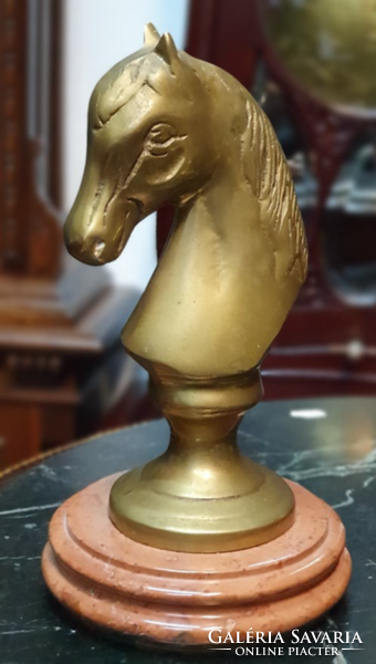 Antique horse head sculpture on a marble pedestal