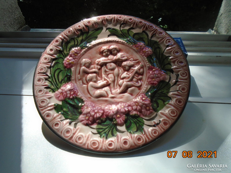 19th century baroque Spanish majolica wall plate with raised musical puttos and flowers