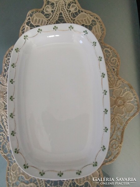 Very old porcelain serving bowl with embossed pattern, gilded garland pattern.