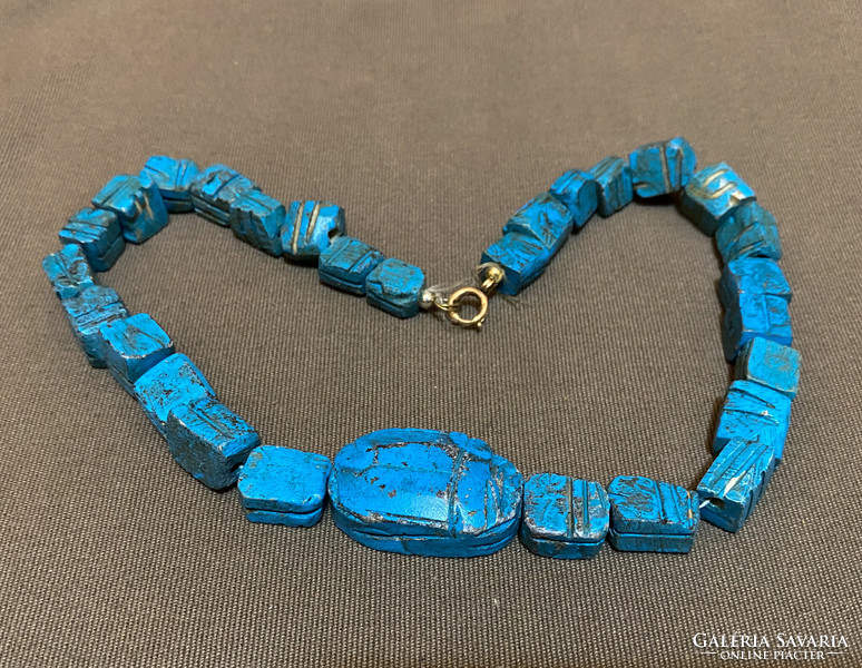 Egyptian ceramic necklace with gold clasp.