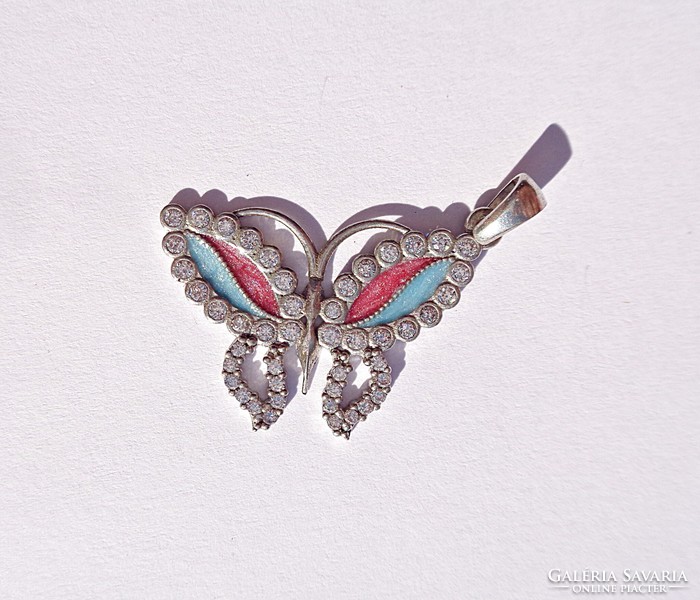 A colorful, multi-stone silver pendant with a butterfly pattern