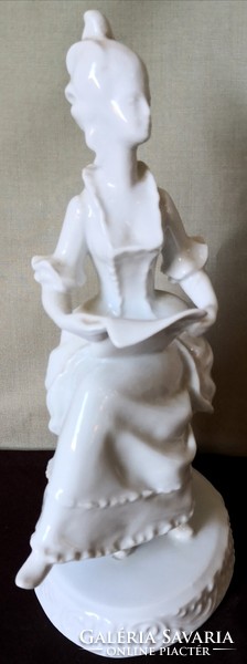 Dt/085 - woman from Hóllóháza, in baroque dress, reading sheet music, porcelain figurine with underglaze