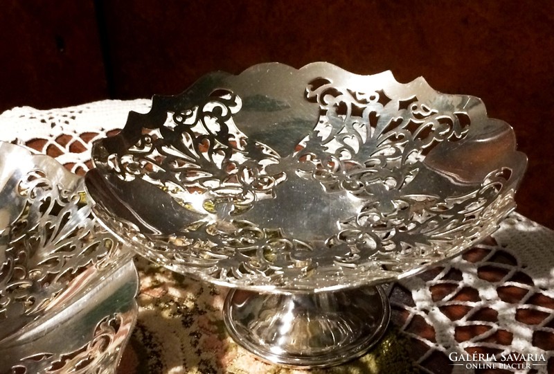 High-gloss, shiny, silver-plated, openwork, serving bowl with handles and a small bowl with a base, with a serving fork