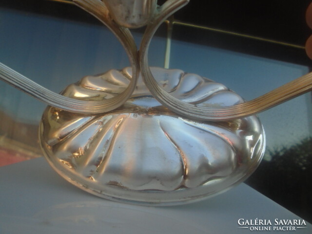 A very finely crafted 3-pronged candle holder with a silver effect