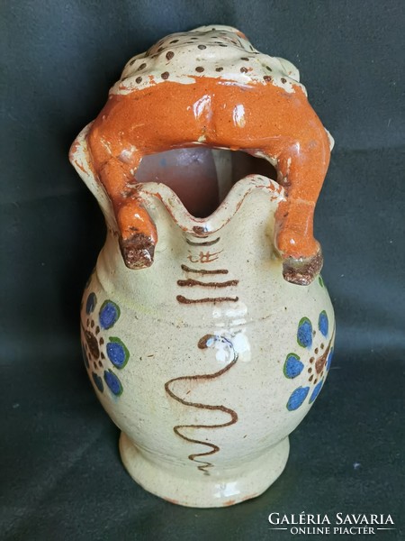 Jug with wine jug on old shield