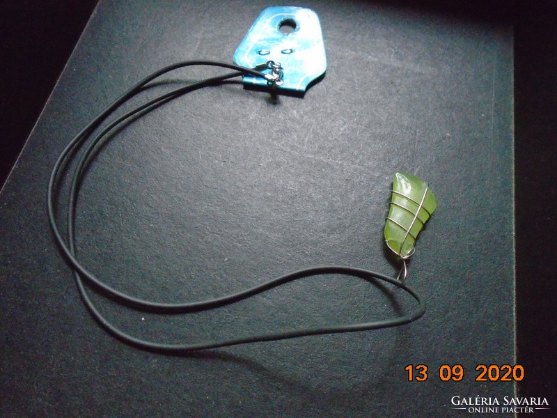 Uranium green mineral pendant with a new label in a metal socket, with a rubber necklace