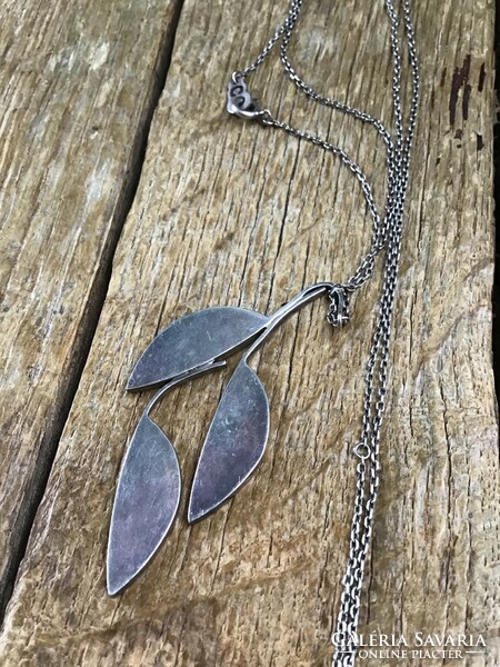 Silver necklace with large silver pendant decorated with leather