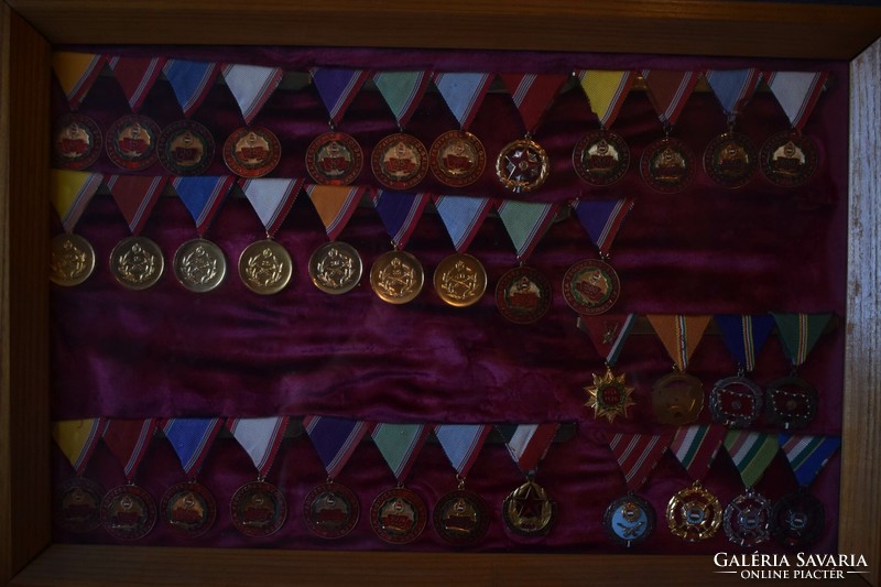 Collection of Soviet and Hungarian awards and badges in 15 glass panels