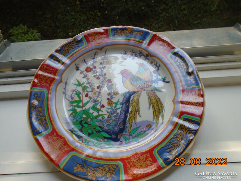 Hand-painted oriental marked wall plate with a bird flower pattern with bright protruding colors