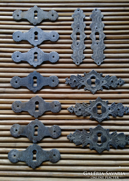 Various antique hammered, chiseled lock covers, 12 in total
