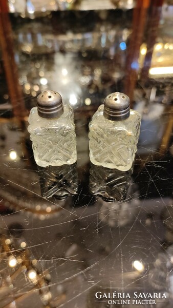 Crystal glass salt and pepper shaker with silver top.