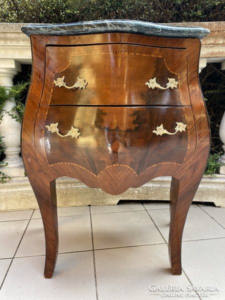 A small dresser with a marble top in a nice shape