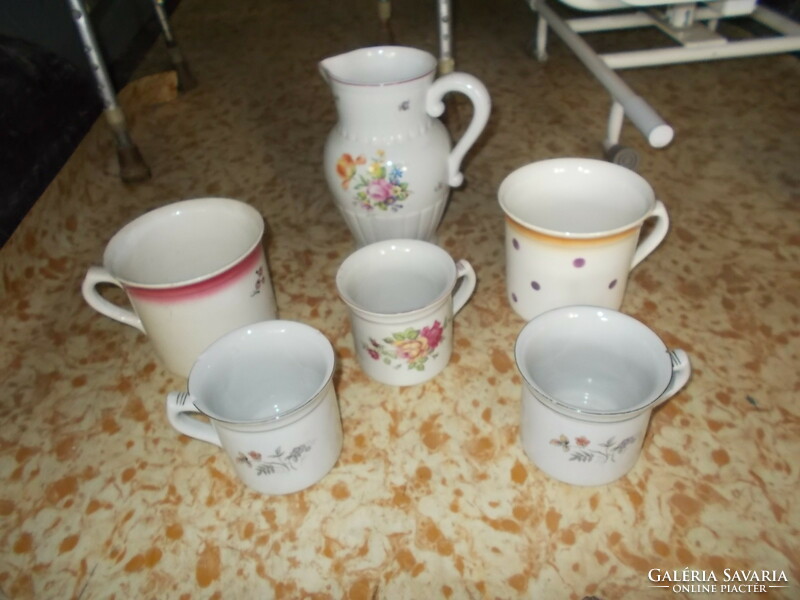 Porcelain jugs and mugs with polka dots and flowers.