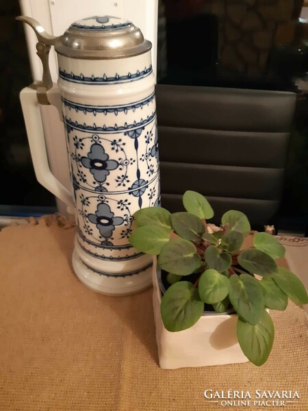 A giant ceramic jug with a tin lid with a ceramic insert