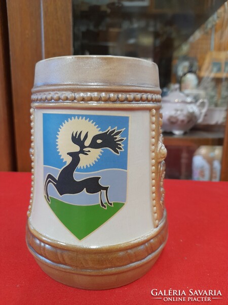 Ceramic jug with deer pattern.