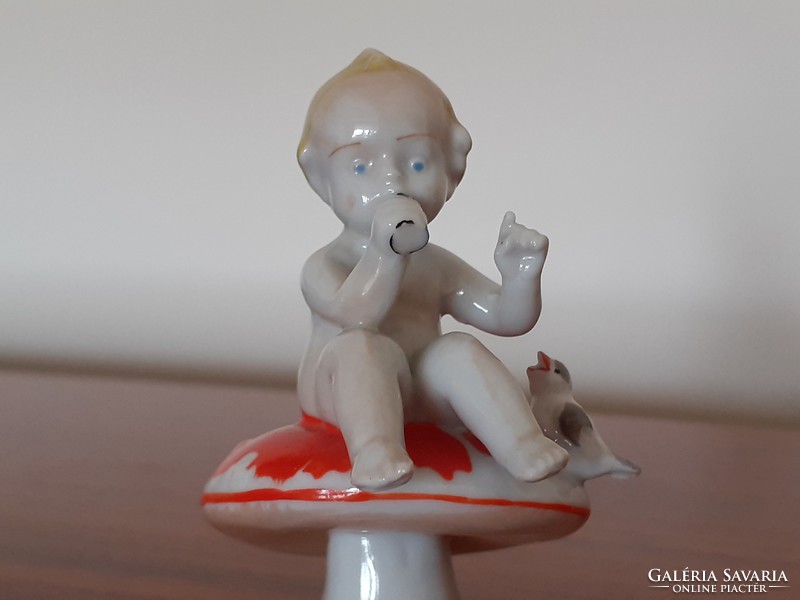 Old metzler & ortloff baby sitting on miniature porcelain mushrooms
