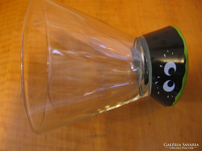 Retro glass with eyes. The bottom of the glass looks back