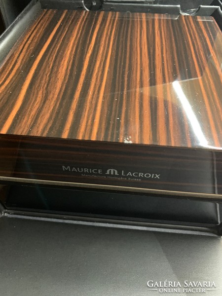 Maurice lacroix installation with glass back in a large wooden box