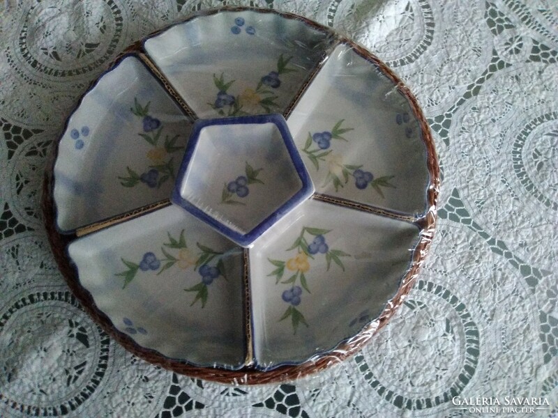 Porcelain seven-part divided serving tray with a woven coaster with a small pattern.