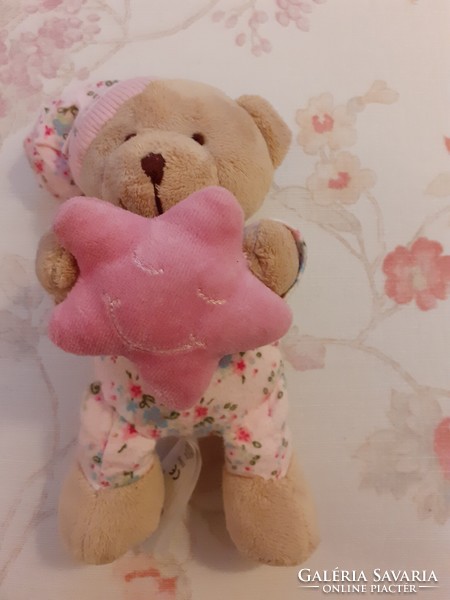 Teddy bear - early days plush bear in pajamas with a cap and a pink star in his hand