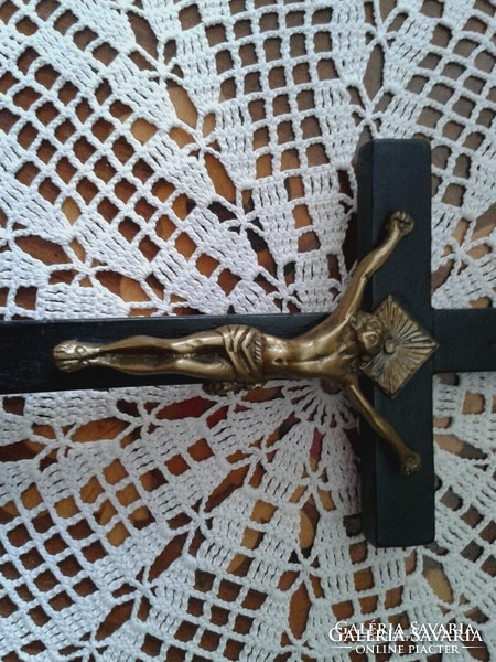 Old wooden cross in black with copper jesus pictures