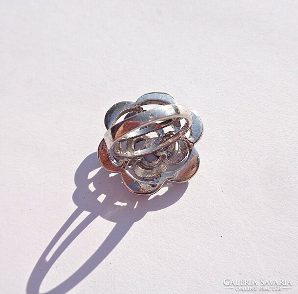 Silver ring with many stones and flower pattern