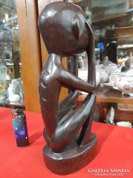 Hand-carved solid wood figural sculpture.