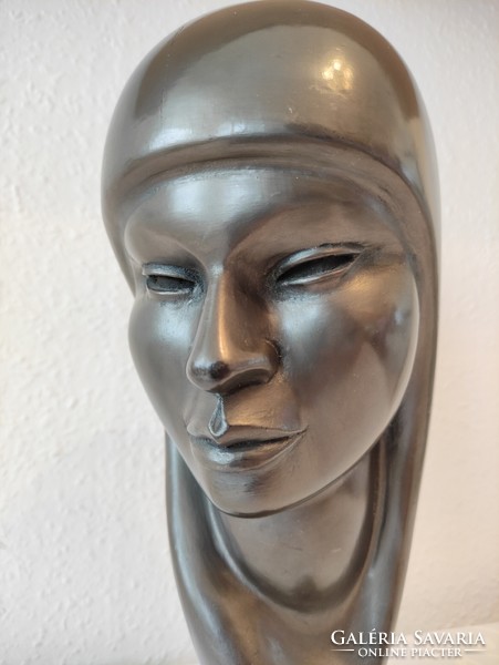 Beautiful large female head statue carved from light wood covered with waterproof material