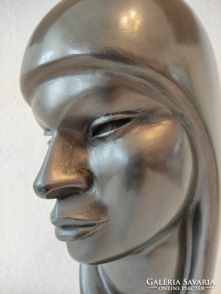 Beautiful large female head statue carved from light wood covered with waterproof material