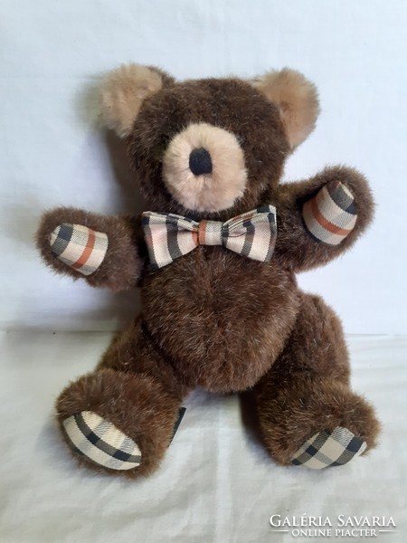 In a nice, well-preserved condition, with a branded teddy bear bow tie around the neck