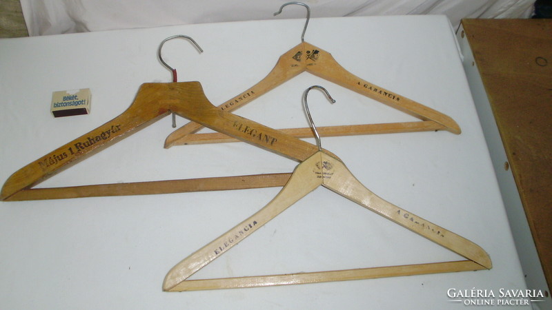 Three suits, pants hangers - together - with 