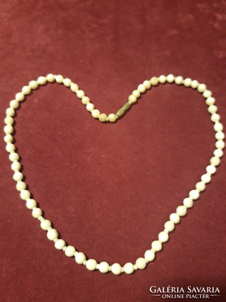 Short string of beads carved from bone - 44 cm