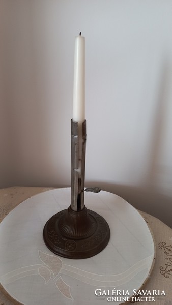 Antique candle holder made of iron, the base is richly decorated, the height of the candle can be adjusted using the small tab