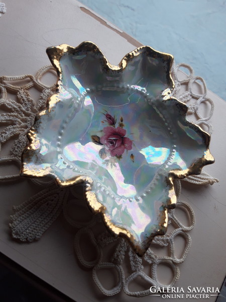 An old small bowl with a mother-of-pearl luster and a frilled golden rim