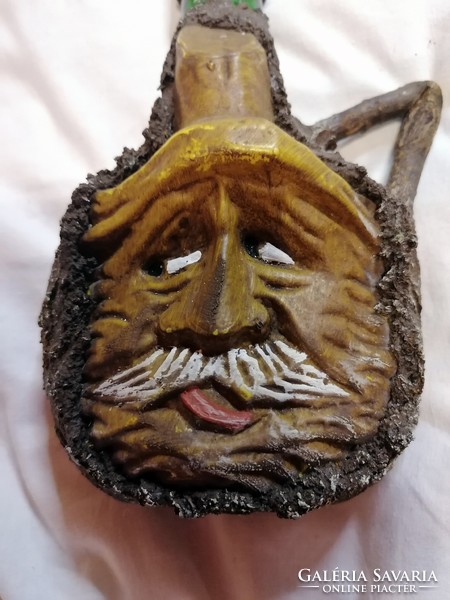 Glass bottle with an old man's face