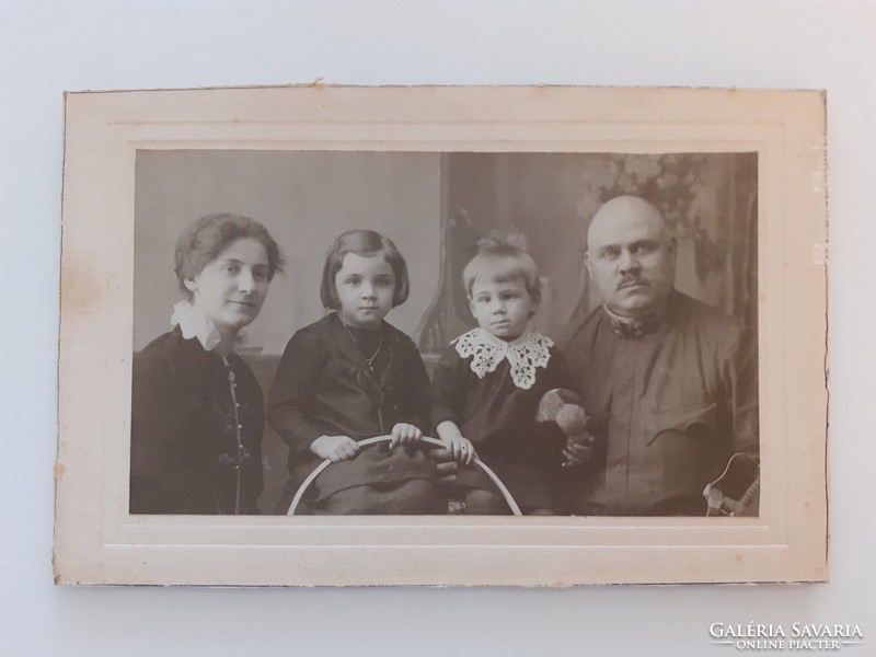 Old family photo of soldier and his family in vintage studio photo