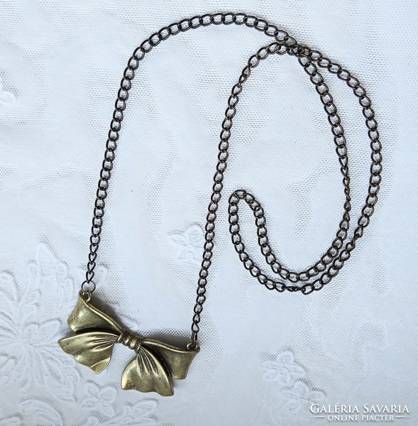 Antique bronze colored metal bow necklace