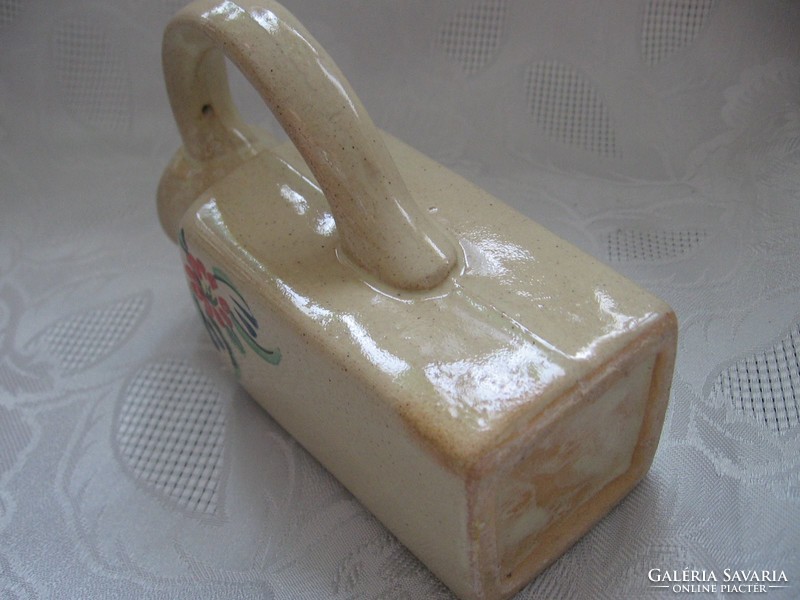 Old handmade ceramic jug with drapery